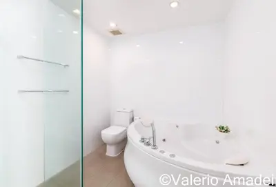 a white bathroom with a tub and a toilet at KB Apartments Karon Beach by PHR in Karon Beach