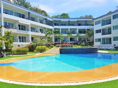 an empty swimming pool in front of a building at KB Apartments Karon Beach by PHR in Karon Beach