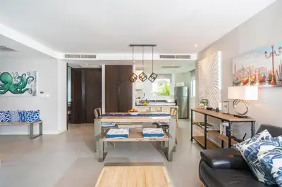 a living room with a couch and a table at Karon Sea View Beach Apartment in Karon Beach