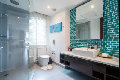 a bathroom with a sink and a toilet and a mirror at Karon Sea View Beach Apartment in Karon Beach