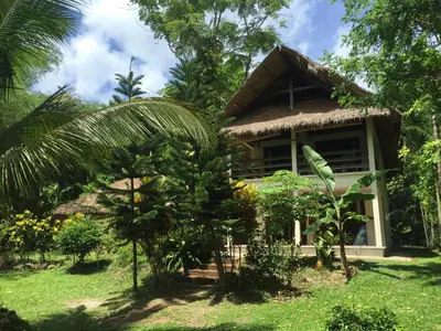 a small house in the middle of a forest at Koyao Bay Pavilions - Beach Resort and Pool Villas in Ko Yao Noi