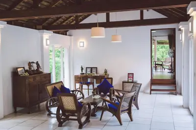 a room with chairs and a table with blue pillows at Koyao Bay Pavilions - Beach Resort and Pool Villas in Ko Yao Noi