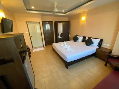 a bedroom with a large white bed in a room at Star Guesthouse in Patong Beach