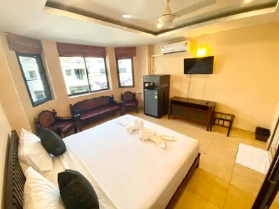 a bedroom with a white bed in a room at Star Guesthouse in Patong Beach