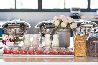 a buffet with jars of food and bottles of milk at Simplitel in Karon Beach