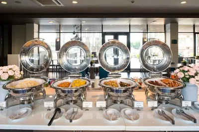 a buffet with several dishes of food on a counter at Simplitel in Karon Beach