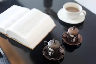 a book and two cups of coffee on a table at Simplitel in Karon Beach