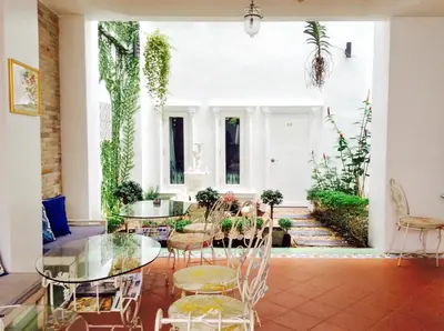 a dining room with a glass table and chairs at Casa Blanca Boutique Hotel - SHA Plus in Phuket Town