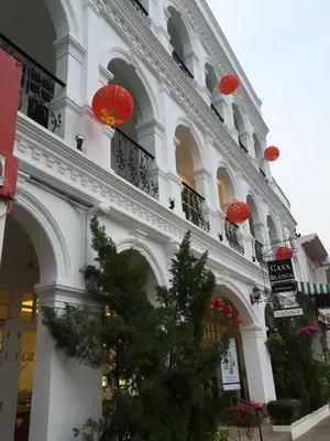 a large white building with red lanterns on it at Casa Blanca Boutique Hotel - SHA Plus in Phuket Town