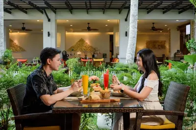 a man and a woman sitting at a table at Centara Anda Dhevi Resort & Spa Krabi in Ao Nang Beach