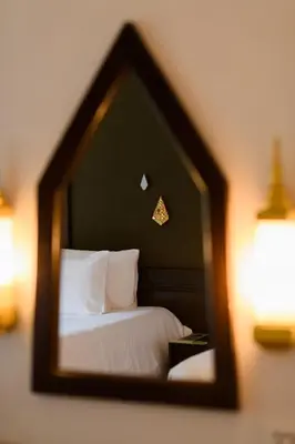 a reflection of a bed in a mirror at Centara Anda Dhevi Resort & Spa Krabi in Ao Nang Beach