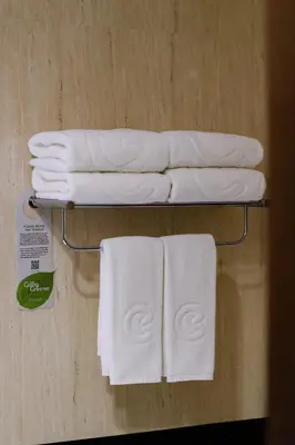 a towel rack with white towels on it at Centara Anda Dhevi Resort & Spa Krabi in Ao Nang Beach