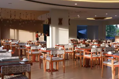 a dining room with tables and chairs and people at Sea Seeker Krabi Resort in Ao Nang Beach