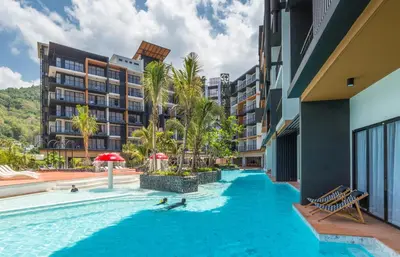 a pool at a hotel with people swimming in it at Sea Seeker Krabi Resort in Ao Nang Beach