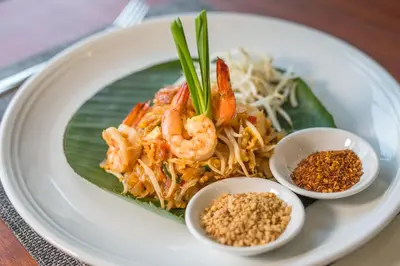 a plate of food with shrimp on a banana leaf at Sea Seeker Krabi Resort in Ao Nang Beach
