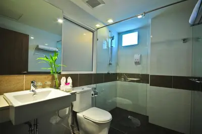 a bathroom with a toilet and a sink and a shower at ASHLEE Plaza Patong Hotel & Spa in Patong Beach