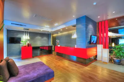 a lobby with a red and blue wall at ASHLEE Heights Hotel Patong in Patong Beach