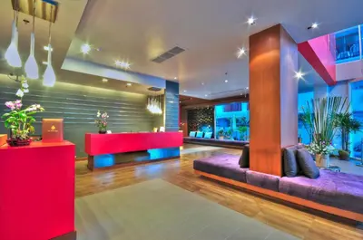 a lobby with red and purple furniture and windows at ASHLEE Heights Hotel Patong in Patong Beach