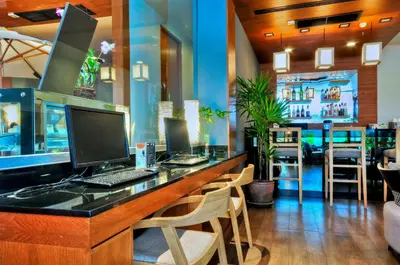 a bar with a desk with a computer on it at ASHLEE Heights Hotel Patong in Patong Beach