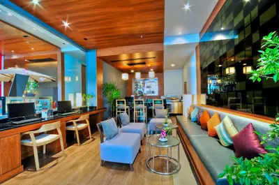 a lobby with a couch and chairs and a bar at ASHLEE Heights Hotel Patong in Patong Beach