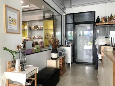 a shop with a black couch in a room at Sleep Sheep Phuket Hostel SHA in Phuket Town