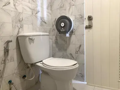 a bathroom with a white toilet in a room at Sleep Sheep Phuket Hostel SHA in Phuket Town