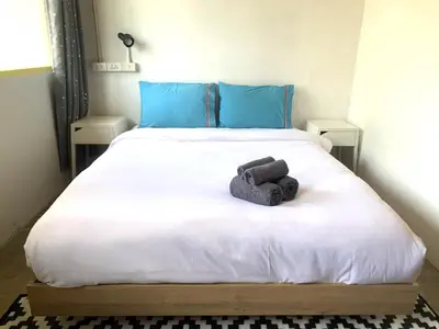 a bedroom with a bed with a towel on it at Sleep Sheep Phuket Hostel SHA in Phuket Town