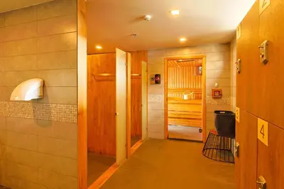 a hallway leading to a bathroom with a door at Gu Hotel Patong in Patong Beach