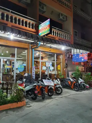 a row of motorcycles parked in front of a store at Andaman Sea Patong in Patong Beach