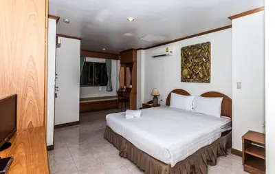 a hotel room with a bed and a television at Andaman Sea Patong in Patong Beach