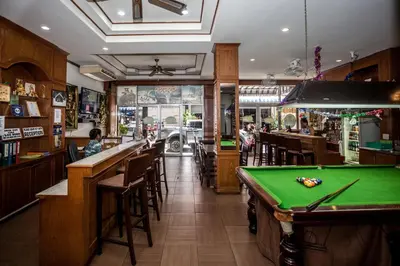 a bar with a pool table in a restaurant at Andaman Sea Patong in Patong Beach