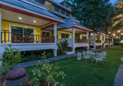 a house with a table and chairs in the yard at Lemon House in Patong Beach