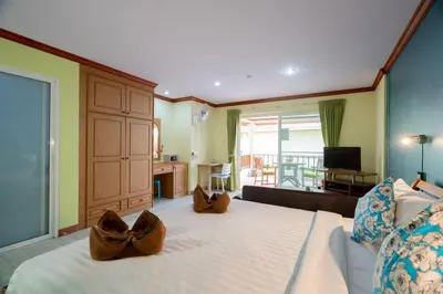 a bedroom with a large bed with shoes on it at Lemon House in Patong Beach