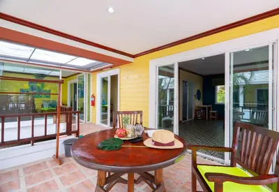 a dining room with a table and chairs on a porch at Lemon House in Patong Beach