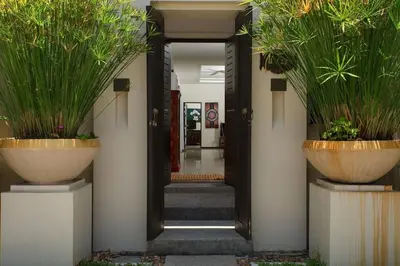 a hallway with two large pots with plants in them at VILLA Atarata Private Pool Nai Harn Beach in Rawai Beach