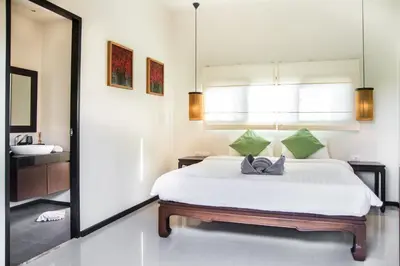 a bedroom with a large white bed and a mirror at VILLA Atarata Private Pool Nai Harn Beach in Rawai Beach
