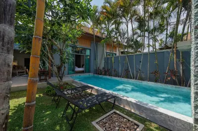 a pool with two chairs and a house at VILLA AWA Private Pool Naiharn beach in Rawai Beach