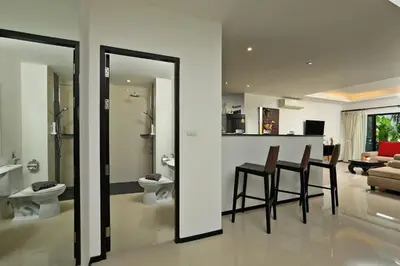 a kitchen and living room with a table and chairs at VILLA Emiemi Pool Thaimond Residence Naiharn in Rawai Beach