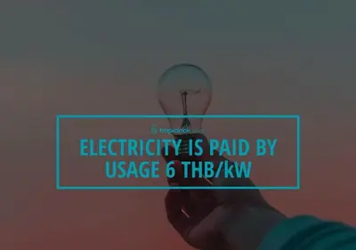 a hand holding a sign that reads electricity is paid by usage thekm at VILLA Emiemi Pool Thaimond Residence Naiharn in Rawai Beach