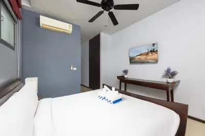 a bedroom with two beds and a ceiling fan at Villa Hahana Private Pool Near Nai Harn Beach in Rawai Beach