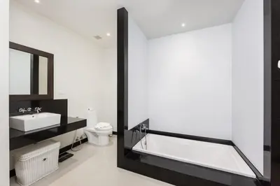 a bathroom with a tub and a sink and a toilet at Villa Hahana Private Pool Near Nai Harn Beach in Rawai Beach