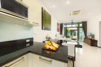 a kitchen with a counter with a bowl of fruit at Villa Hahana Private Pool Near Nai Harn Beach in Rawai Beach