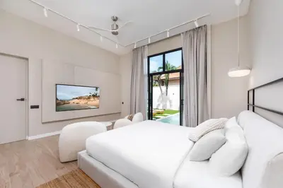 a white bedroom with a white bed and a white couch at VILLA MIOS Private Pool 3 min Nai Harn Beach in Nai Harn Beach