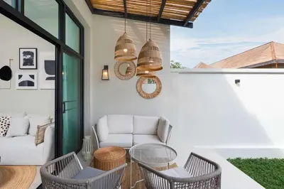 a patio with a couch and a table and chairs at VILLA MIOS Private Pool 3 min Nai Harn Beach in Nai Harn Beach