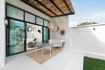 a dining room with a table and chairs on a patio at VILLA MIOS Private Pool 3 min Nai Harn Beach in Nai Harn Beach