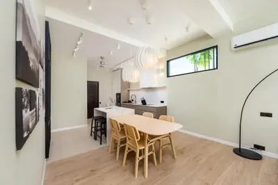 a kitchen and dining room with a table and chairs at VILLA MIOS Private Pool 3 min Nai Harn Beach in Nai Harn Beach
