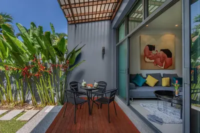 a patio with a table and chairs and a couch at VILLA Iotama Private Pool Nai Harn Beach in Rawai Beach