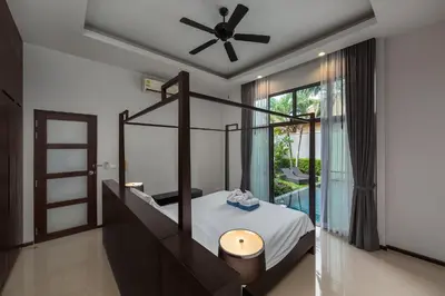 a bedroom with a bed and a ceiling fan at VILLA JAVA Private Pool Nai Harn Beach in Rawai Beach