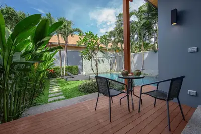 a patio with a table and chairs on a deck at VILLA JAVA Private Pool Nai Harn Beach in Rawai Beach