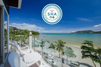 a view of the beach from the balcony of a resort at The Front Hotel and Apartments in Patong Beach